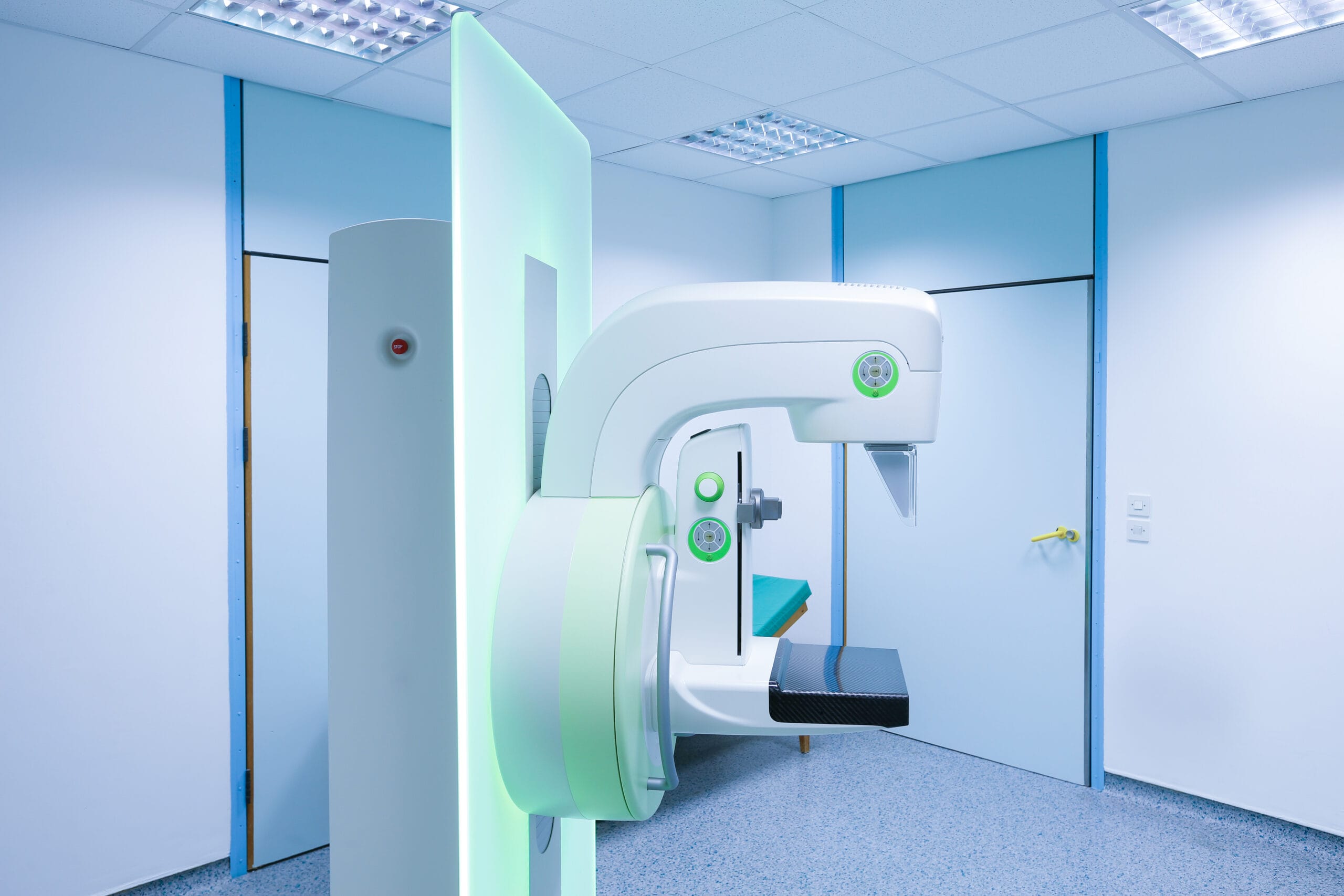 Radiographer operating imaging equipment in a clinical room